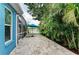 A serene outdoor living space with lake views, comfortable lounge chairs, and a vibrant turquoise umbrella at 220 39Th Ne St, Bradenton, FL 34208