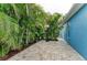 Paved patio with lush tropical landscaping and basketball hoop for outdoor activities at 220 39Th Ne St, Bradenton, FL 34208
