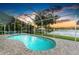 Relaxing screened pool overlooking a tranquil lake, complete with comfortable seating and picturesque views at 220 39Th Ne St, Bradenton, FL 34208