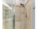Close up of the large shower, featuring pebble flooring, built-in shelving, and dual shower heads at 220 39Th Ne St, Bradenton, FL 34208