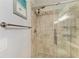 Up close view of the glass shower with dual shower heads, neutral tile and pebble floor at 220 39Th Ne St, Bradenton, FL 34208