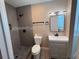 Modern bathroom features updated vanity, mirror, lighting and tiled walk-in shower at 2629 14Th S Ave, St Petersburg, FL 33712