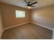 Cozy bedroom features a ceiling fan, vinyl floor and a window at 2629 14Th S Ave, St Petersburg, FL 33712