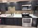 Updated kitchen with stainless appliances, tile backsplash and quartz countertops at 2629 14Th S Ave, St Petersburg, FL 33712