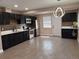 Modern kitchen features stainless steel appliances, tiled floors and black cabinets at 2629 14Th S Ave, St Petersburg, FL 33712