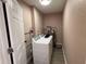 Laundry room with a modern washer, dryer, and a water heater at 2629 14Th S Ave, St Petersburg, FL 33712