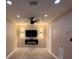 This living room boasts recessed lighting, a ceiling fan, and an electric fireplace below the mounted TV at 2629 14Th S Ave, St Petersburg, FL 33712