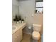 Cozy bathroom featuring a toilet, a clean single sink vanity, and a small window at 3262 Brunswick Ln # 707, Sarasota, FL 34239