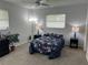 Comfortable bedroom with a ceiling fan and floral bedding at 3262 Brunswick Ln # 707, Sarasota, FL 34239