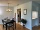 Bright dining area with a chandelier and seating for four adjacent to the stainless steel kitchen at 3262 Brunswick Ln # 707, Sarasota, FL 34239