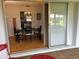 Charming dining area featuring a chandelier, wood floors, and a view to the backyard at 3262 Brunswick Ln # 707, Sarasota, FL 34239