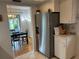 View of the stainless steel refrigerator adjacent to the dining area at 3262 Brunswick Ln # 707, Sarasota, FL 34239