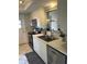 Close up of kitchen with updated stainless steel appliances, sink and white cabinets at 3262 Brunswick Ln # 707, Sarasota, FL 34239