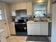 Kitchen with updated stainless steel appliances, double basin sink, and white cabinetry at 3262 Brunswick Ln # 707, Sarasota, FL 34239