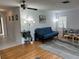 Bright living room with a gray sofa, a futon, hardwood floors, and modern decor at 3262 Brunswick Ln # 707, Sarasota, FL 34239