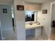 Open desk area with a pass through to the living room and overhead cabinets at 3262 Brunswick Ln # 707, Sarasota, FL 34239
