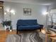 Comfortable living room featuring a futon, gray couch, hardwood floors, and abundant natural light at 3262 Brunswick Ln # 707, Sarasota, FL 34239