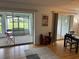 Open-concept living area showcasing access to both the screened-in lanai and adjacent dining room at 3262 Brunswick Ln # 707, Sarasota, FL 34239