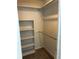 Walk-in closet with carpet and rod for hanging clothing, also features built-in shelving at 3262 Brunswick Ln # 707, Sarasota, FL 34239
