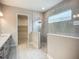 Bathroom showcasing a modern walk-in shower, neutral tones, and a view into the walk-in closet at 3512 Cross Creek Pkwy, Parrish, FL 34219