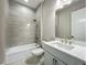 Clean bathroom with modern fixtures, gray tile, and a vanity with a marble countertop, complemented by an updated shower at 3512 Cross Creek Pkwy, Parrish, FL 34219