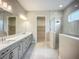 Bright bathroom featuring double sinks, ample counter space, and a walk-in shower with gray tile at 3512 Cross Creek Pkwy, Parrish, FL 34219