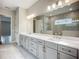 Bathroom features a long vanity with double sinks, granite countertops, and a large mirror at 3512 Cross Creek Pkwy, Parrish, FL 34219