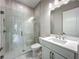 Modern bathroom features a glass-enclosed shower and vanity with white countertop at 3512 Cross Creek Pkwy, Parrish, FL 34219