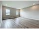 Bright bedroom with hardwood floors, featuring two windows that provide natural light, and neutral walls for versatile decor at 3512 Cross Creek Pkwy, Parrish, FL 34219