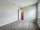Neutral bedroom features wood-look floors and an open door at 3512 Cross Creek Pkwy, Parrish, FL 34219
