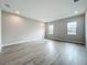 Spacious bedroom with hardwood flooring, neutral walls, recessed lighting, and two large windows offering natural light at 3512 Cross Creek Pkwy, Parrish, FL 34219