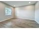 Bright bedroom features wood-look floors and a window at 3512 Cross Creek Pkwy, Parrish, FL 34219