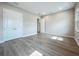 Bright bedroom features wood-look flooring, closet, and an open door to another room at 3512 Cross Creek Pkwy, Parrish, FL 34219