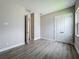 Neutral bedroom features wood-look flooring, closet, and an open door to another room at 3512 Cross Creek Pkwy, Parrish, FL 34219