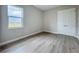 Bedroom features wood-look floors, a window, and a closet at 3512 Cross Creek Pkwy, Parrish, FL 34219