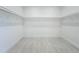 Walk-in closet provides ample storage space with shelving and rod racks at 3512 Cross Creek Pkwy, Parrish, FL 34219
