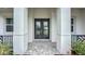 Close up of elegant glass paneled double front doors and walkway with pillars and professional landscaping at 3512 Cross Creek Pkwy, Parrish, FL 34219