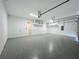 Well-lit garage features ample space, storage shelving, and door to the house at 3512 Cross Creek Pkwy, Parrish, FL 34219