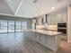 Open kitchen with a large island, stainless steel appliances, and scenic views of the patio, pool, and lake at 3512 Cross Creek Pkwy, Parrish, FL 34219