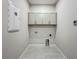 Spacious laundry room includes overhead cabinets and modern tiling at 3512 Cross Creek Pkwy, Parrish, FL 34219