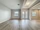 Light-filled living room features wood floors, neutral paint, backyard views, and access to other areas of the home at 3512 Cross Creek Pkwy, Parrish, FL 34219