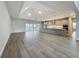 Open concept living room boasts modern lighting, views of the kitchen and backyard lake at 3512 Cross Creek Pkwy, Parrish, FL 34219