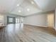 Open living space with recessed lighting, hardwood floors, and views of the front entrance and kitchen at 3512 Cross Creek Pkwy, Parrish, FL 34219