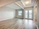 Spacious living room featuring wood floors, recessed lighting, and access to outdoor patio at 3512 Cross Creek Pkwy, Parrish, FL 34219