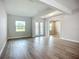 Bright living room showcasing hardwood floors, a window with a view, and stylish double doors at 3512 Cross Creek Pkwy, Parrish, FL 34219