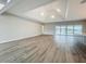 Open living room featuring hardwood floors, recessed lighting, and a sliding glass door showcasing stunning water views at 3512 Cross Creek Pkwy, Parrish, FL 34219