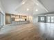 Large living room with hardwood floors, an open-concept kitchen, and access to the front entrance at 3512 Cross Creek Pkwy, Parrish, FL 34219