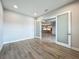 Office features wood-look floors and glass French doors with view of kitchen at 3512 Cross Creek Pkwy, Parrish, FL 34219