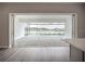 Bright indoor-outdoor transition space with a view of the screened-in patio and pool overlooking the lake at 3512 Cross Creek Pkwy, Parrish, FL 34219