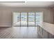 Indoor-outdoor transition featuring sliding glass doors that open to a screened-in patio, pool, and scenic lake at 3512 Cross Creek Pkwy, Parrish, FL 34219